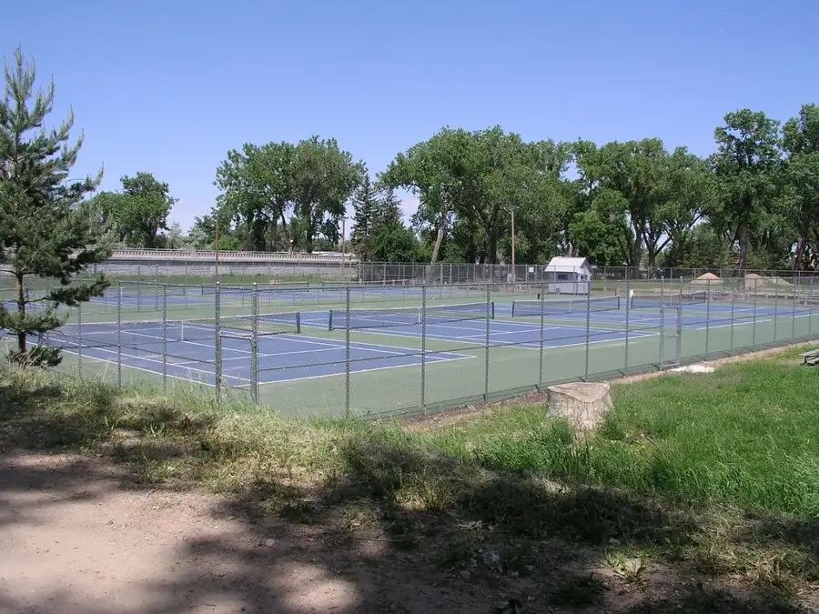 Canchas de tenis cercadas con malla ciclónica alta y postes de acero
